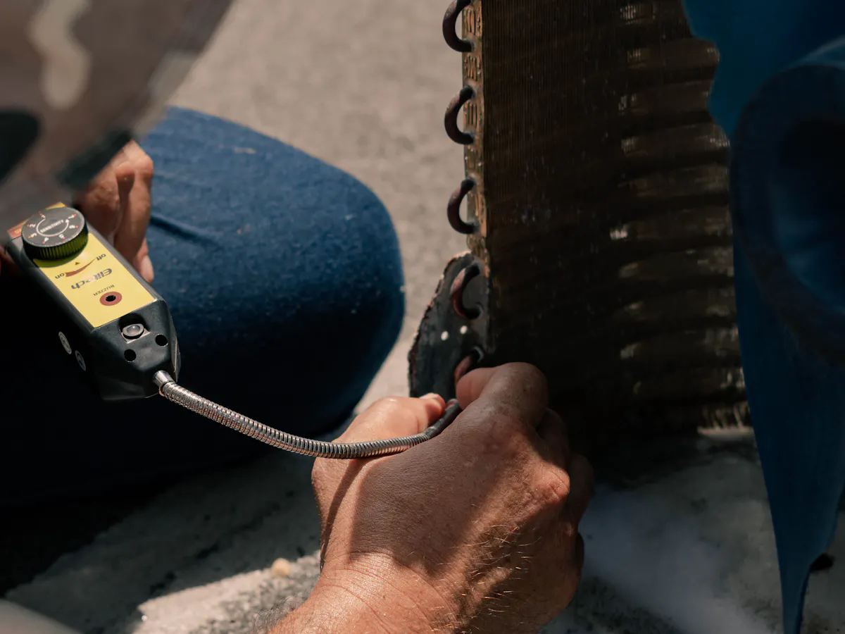 Technician repairing an air conditioning unit